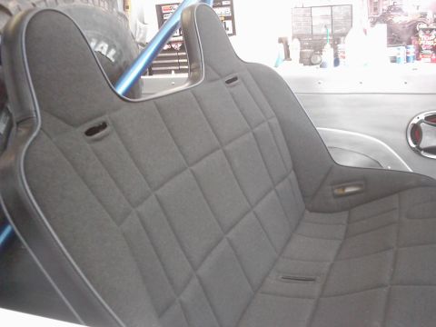 1978 Ford Bronco - The interior features custom upholstered seats and a roll bar, with a spare tire mounted behind the seats.