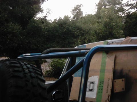 1978 Ford Bronco - Interior view of an off-road vehicle, showing a roll cage and spare tire.