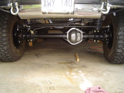 1989 Ford Bronco - Close-up view of a vehicle's rear axle and suspension system, showing mechanical components.