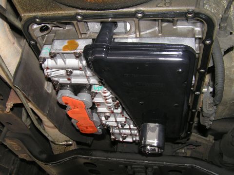 2000 Ford Excursion - Underside view of a transmission pan and filter, showing the filter housing and associated components.