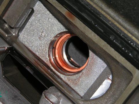 2000 Ford Excursion - A close-up view of a transmission valve body, revealing internal components and fluid staining.