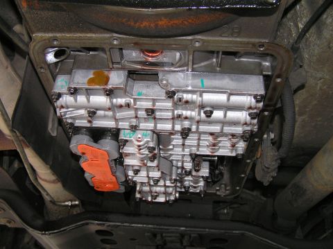 2000 Ford Excursion - Close-up view of a transmission valve body, likely during a repair or installation process.