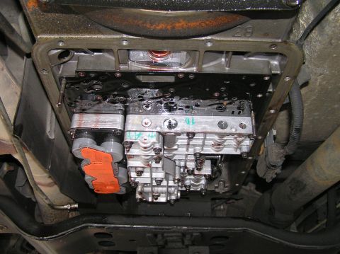 2000 Ford Excursion - Close-up of a vehicle's transmission valve body, showing internal components and wiring.
