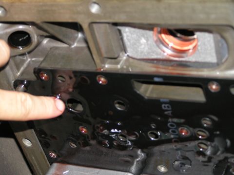 2000 Ford Excursion - Transmission valve body showing fluid and internal components, likely during a service.