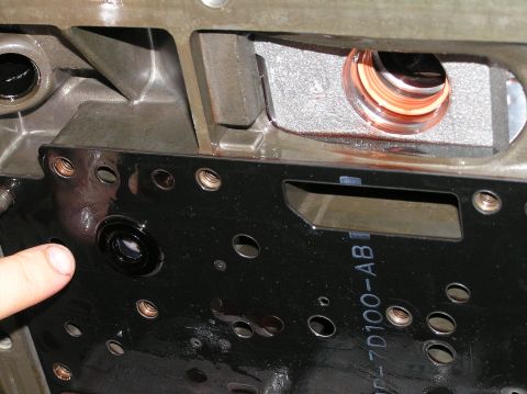 2000 Ford Excursion - A close-up view of a transmission valve body, showing internal components and some visible text.