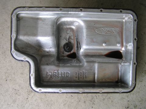2000 Ford Excursion - Ford transmission pan, likely from a truck or SUV, showing the gasket and drain plug.