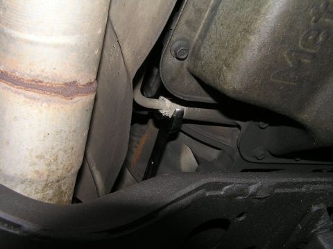 2000 Ford Excursion - Close-up view of undercarriage components, including an exhaust pipe and transmission pan.