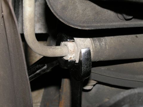 2000 Ford Excursion - Mechanic uses wrenches to install a remote transmission filter.