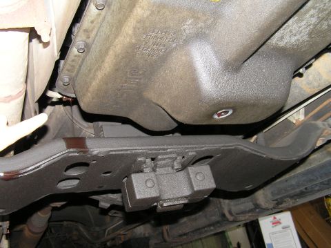 2000 Ford Excursion - A close-up view of a transmission filter installation on the underside of a vehicle.