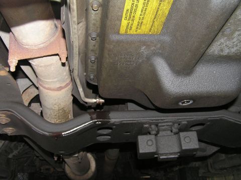 2000 Ford Excursion - Transmission pan and exhaust system visible from underneath the vehicle.
