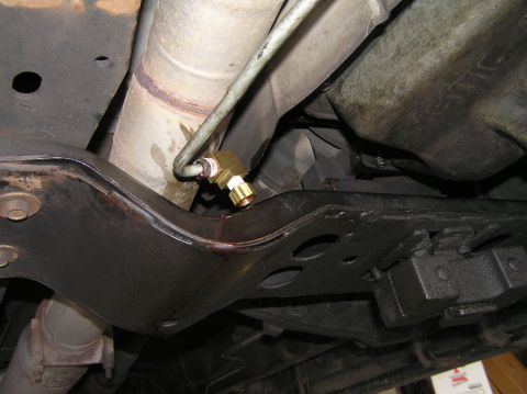 2000 Ford Excursion - Close-up view of a transmission filter installation on the underbody of a vehicle.