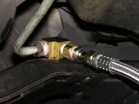 2000 Ford Excursion - Transmission fluid line T-fitting with braided metal hose connection.
