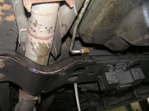 2000 Ford Excursion - Underside view of a vehicle's exhaust system and a newly installed transmission filter.