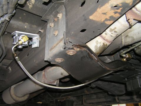 2000 Ford Excursion - Undercarriage view of a vehicle, focusing on brake lines and exhaust system components.