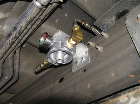 2000 Ford Excursion - Underside view of a vehicle showing a newly installed remote transmission filter and gauge assembly.