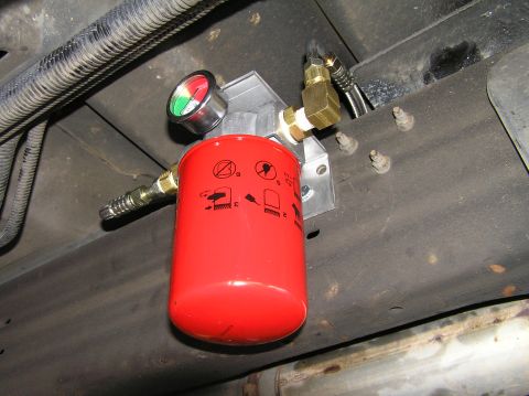2000 Ford Excursion - Remote transmission filter installation with a gauge showing pressure.