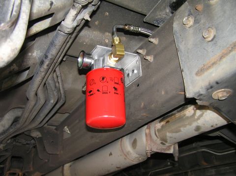 2000 Ford Excursion - A remote transmission filter is installed on the vehicle's frame, with associated plumbing and a gauge visible.