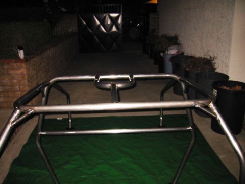1985 Ford Bronco - Custom metal roll cage frame assembly shown on a green tarp.