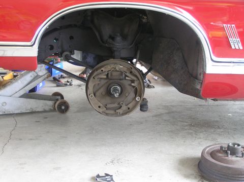 1967 Ford Galaxie - Close-up of a car's rear drum brake assembly during maintenance.