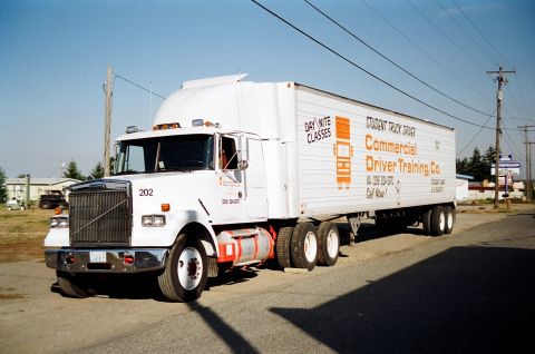 1976 Ford F-150 - Commercial Driver Training Co. semi-truck and trailer parked on a sunny day.