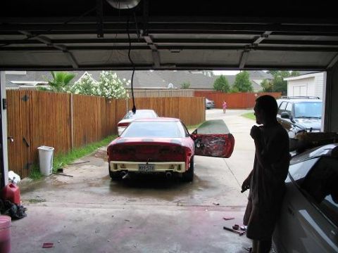 1994 Ford Probe - A red 1994 Ford Probe sits in a garage with its driver's door open, showing interior work.