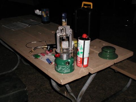 1992 Ford Taurus - Outdoor gear, including a lantern and fuel, is set up on a picnic table.