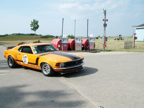 1992 Ford Taurus - This 1970 Ford Mustang Boss 302 race car is seen at a retro gas station with vintage pumps.