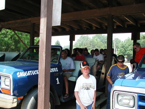 1992 Ford Taurus - A blue pickup truck, possibly a Dodge Ram, is seen with passengers, suggesting it's part of a ride service.