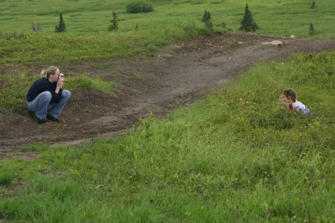 2003 Jeep TJ - Woman photographs children playing in a grassy field with a dirt path.