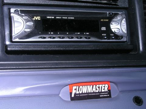 1999 Ford Crown Victoria - Interior view of a car's dashboard a JVC stereo and a Flowmaster sticker.