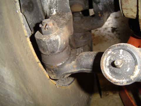 1979 Ford Bronco - Close-up view of a vehicle's steering linkage components, including a tie rod end and ball joint.