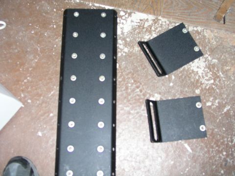 1999 Ford Crown Victoria - Black metal console and brackets are shown, with visible screw holes and a website watermark at the bottom.