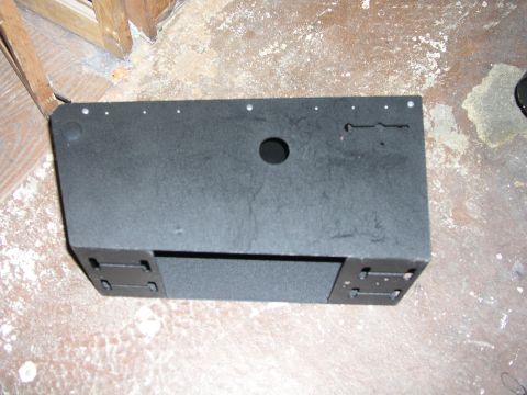 1999 Ford Crown Victoria - A black console part, possibly for a vehicle interior, is shown with mounting brackets and a circular cutout.