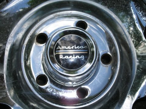 1999 Ford Crown Victoria - Close-up of a chrome wheel an American Racing center cap.