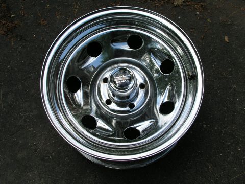 1999 Ford Crown Victoria - A single chrome American Racing wheel is shown against a dark, textured background.