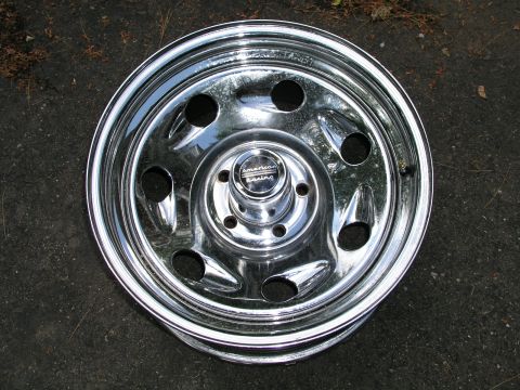 1999 Ford Crown Victoria - A single chrome American Racing wheel is shown against a dark, textured background.