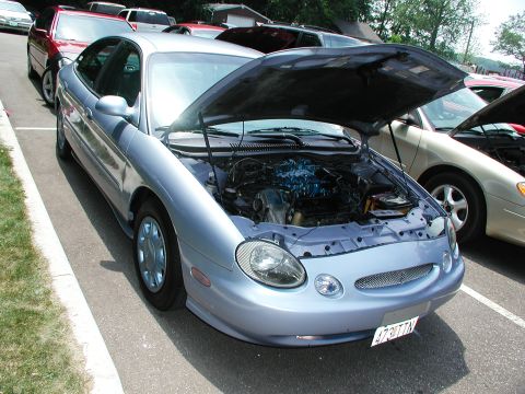 1992 Ford Taurus - This silver sedan's body style and grille indicate a mid-1990s model, not a 1992 Ford Taurus.