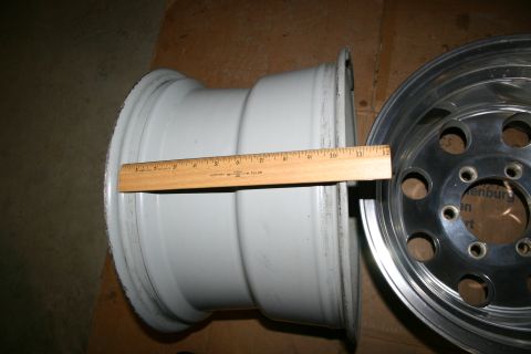 2003 Jeep TJ - A ruler is placed against a white wheel, with a chrome wheel visible to the right.