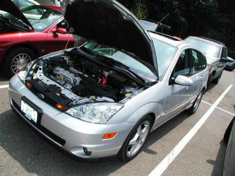 1992 Ford Taurus - Silver sedan with hood open, revealing the engine compartment.