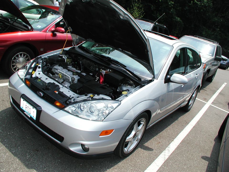 Silver sedan with hood open, showing engine. Front 3/4 view