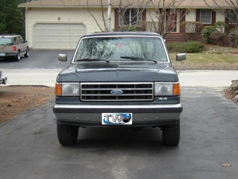 1991 Ford Bronco - This 1991 Ford Bronco is seen from the front, a license plate frame with a logo.