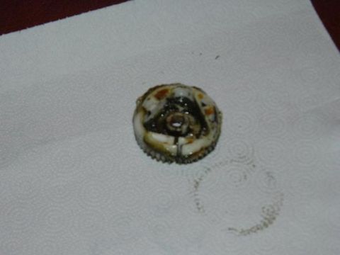 1991 Ford Bronco - A close-up view of a worn mechanical component resting on a paper towel, with a Supermotors.net logo in the lower right corner.