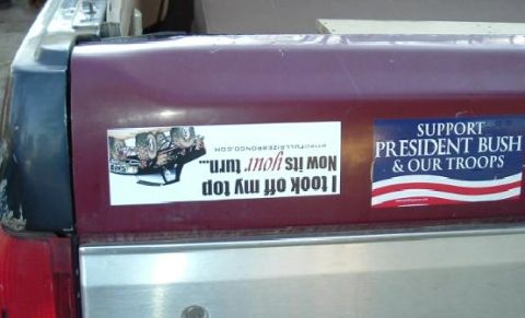 1991 Ford Bronco - A maroon tailgate displays two stickers, one with a humorous message about an overturned vehicle and another supporting President Bush and…