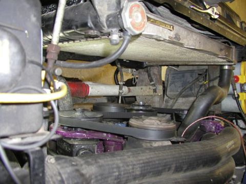 1988 Ford Bronco - Engine bay with the mechanical fan and shroud removed, opening up a clear view of the radiator's top tank and cap, the serpentine belt wrap…