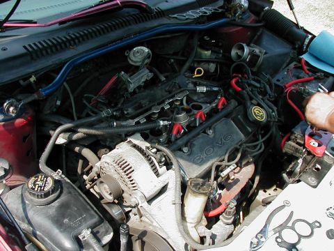 1997 Ford Taurus - Close-up of a car's engine bay, revealing the 3.0L V6 engine and associated components.