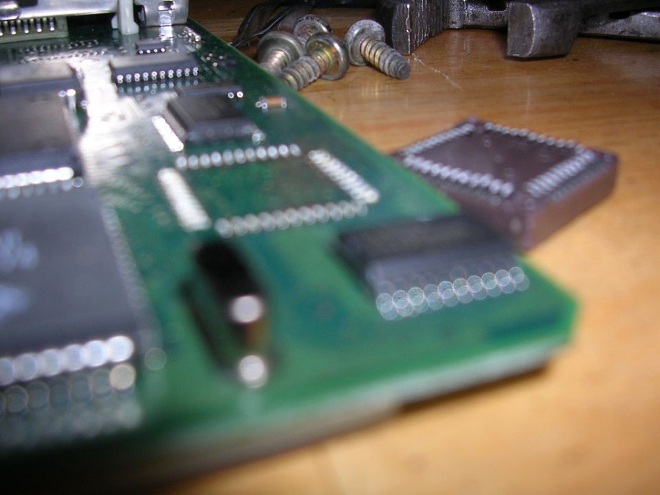 Circuit board with chips and screws, close-up view
