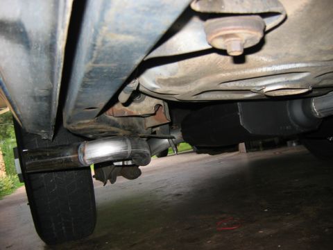 1985 Ford Crown Victoria LTD - Close-up view of the underbody of a vehicle, focusing on the exhaust system components.