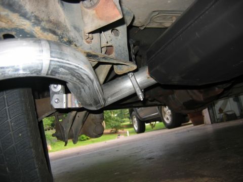 1985 Ford Crown Victoria LTD - A close-up view of a car's exhaust system, showing the muffler and piping.