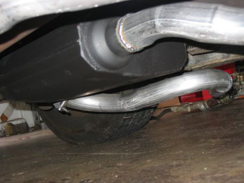 1985 Ford Crown Victoria LTD - The underside of a vehicle shows the exhaust system and a spare tire.