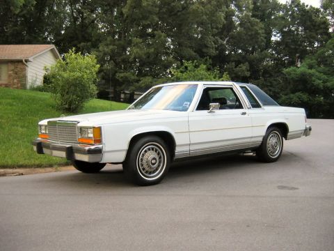 1985 Ford Crown Victoria LTD - White 1985 Ford Crown Victoria LTD two-door sedan parked on a residential street.